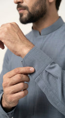 The Silver Blue — walking side profile showing full kurta shalwar silhouette