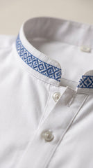 The Pure White — blue geometric embroidered collar trim close-up