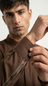 Mud Brown — cuff detail with fabric label