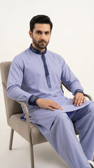 The Periwinkle Blue — seated lifestyle shot styled as kurta shalwar