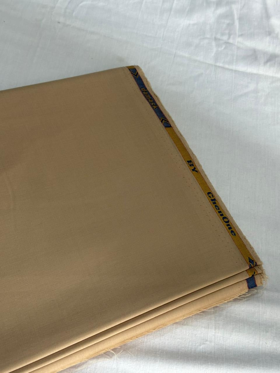 The Camel Sand — flat fabric fold showing weave and selvedge