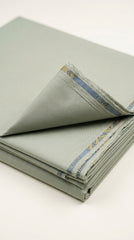 The Pista Green — folded fabric yardage with woven selvedge border