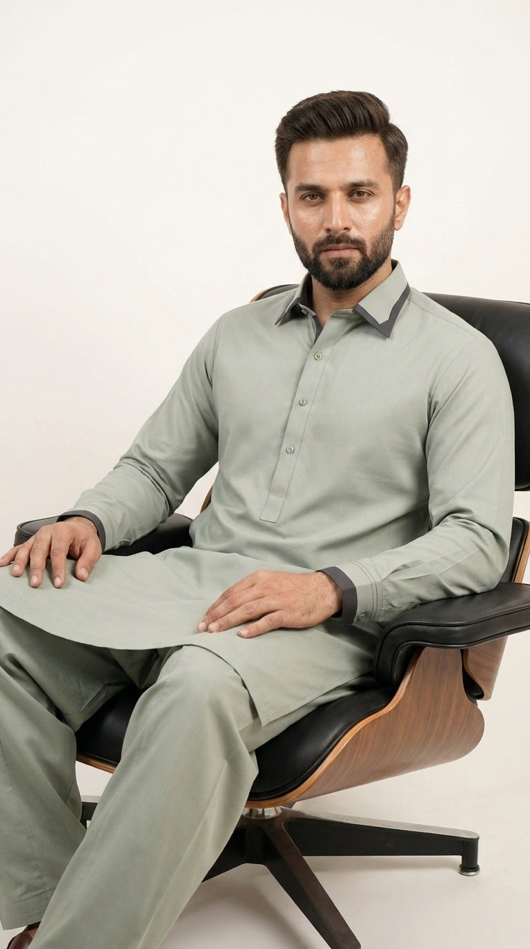 The Pista Green — seated lifestyle shot showing contrast cuffs and full silhouette