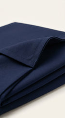 The Deep Ink Navy — seated lifestyle shot with tablet