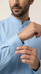 The Sky Blue — walking three-quarter view with kurta shalwar
