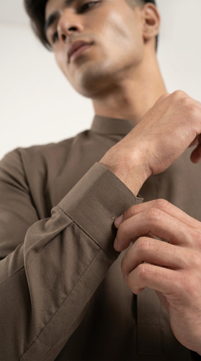 The Choco Brown — seated lifestyle shot with phone and band collar