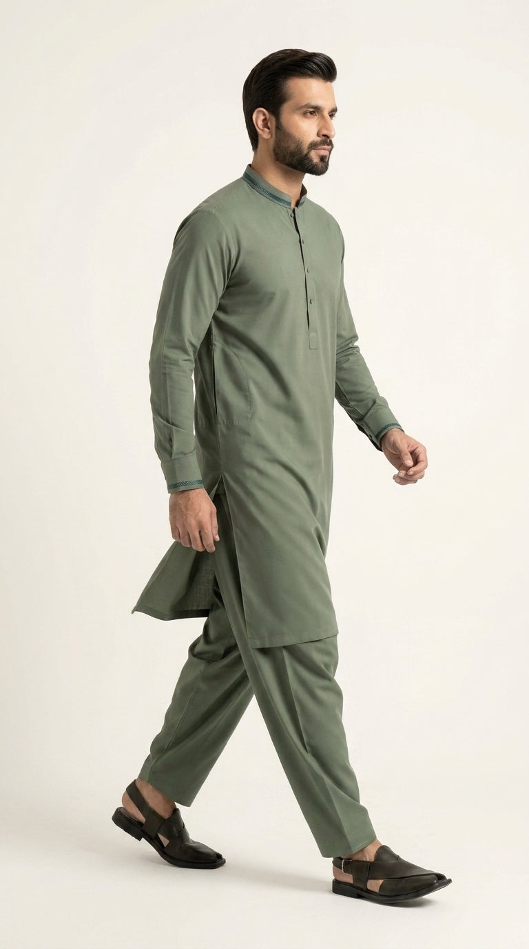 The Pista Green — walking side profile showing full silhouette and drape