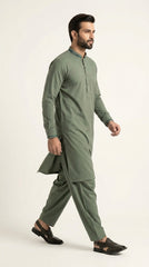 The Pista Green — walking side profile showing full silhouette and drape