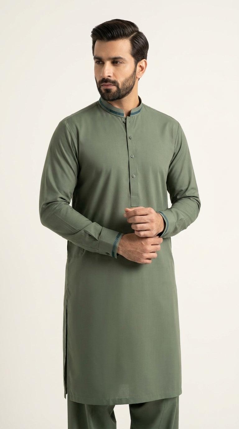 The Pista Green — three-quarter standing view with hands clasped