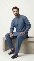 The Steel Blue — walking side profile showing full kurta shalwar silhouette
