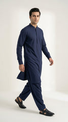 The Navy Blue — walking three-quarter view showing drape and silhouette