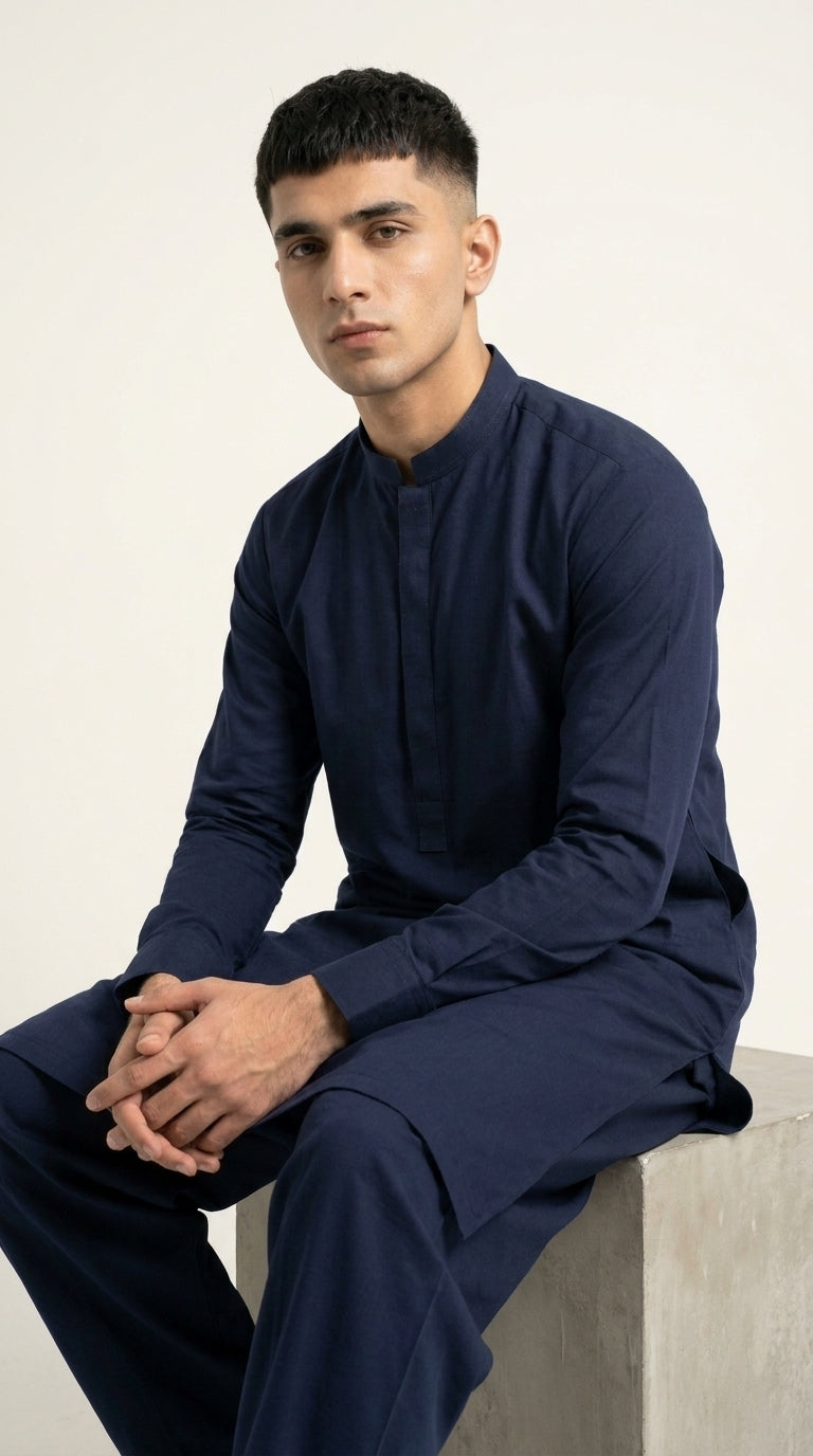 The Navy Blue — seated lifestyle shot with band collar detail