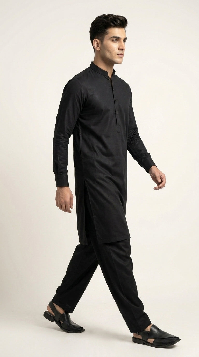 The Jet Black — walking side profile showing drape and silhouette