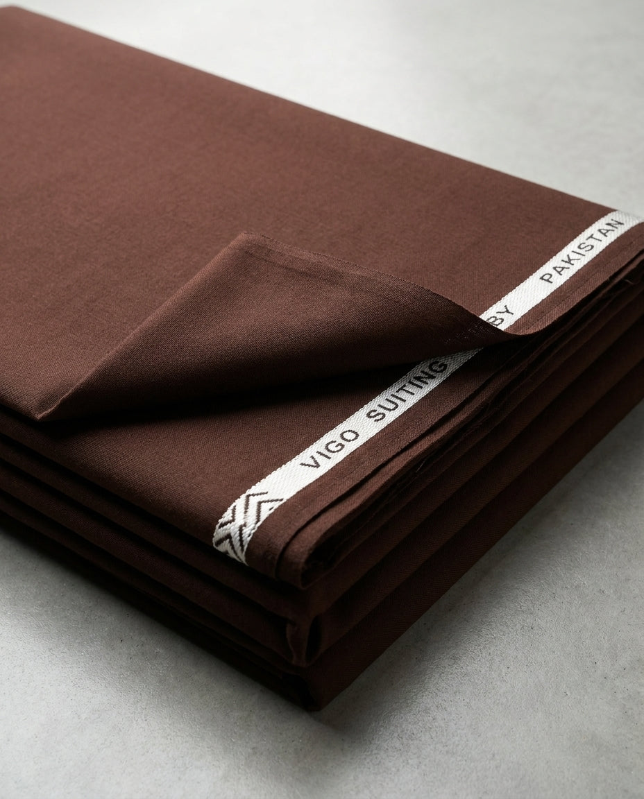 Vigo Star Dark Brown fabric folded flat lay with Vigo Suiting by Pakistan selvedge tape