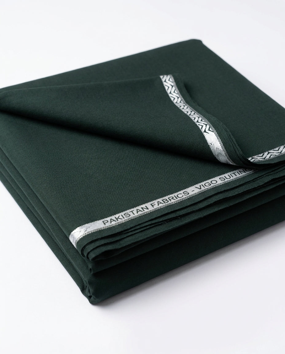 Vigo Star Emerald Green fabric folded with Pakistan Fabrics Vigo Suiting silver selvedge tape