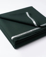 Vigo Star Emerald Green fabric folded with Pakistan Fabrics Vigo Suiting silver selvedge tape